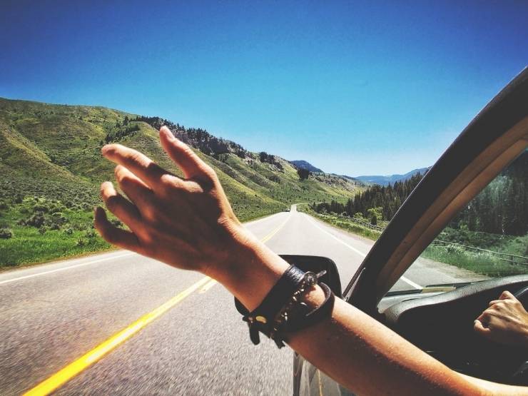 ragazza con mano fuori dall'auto